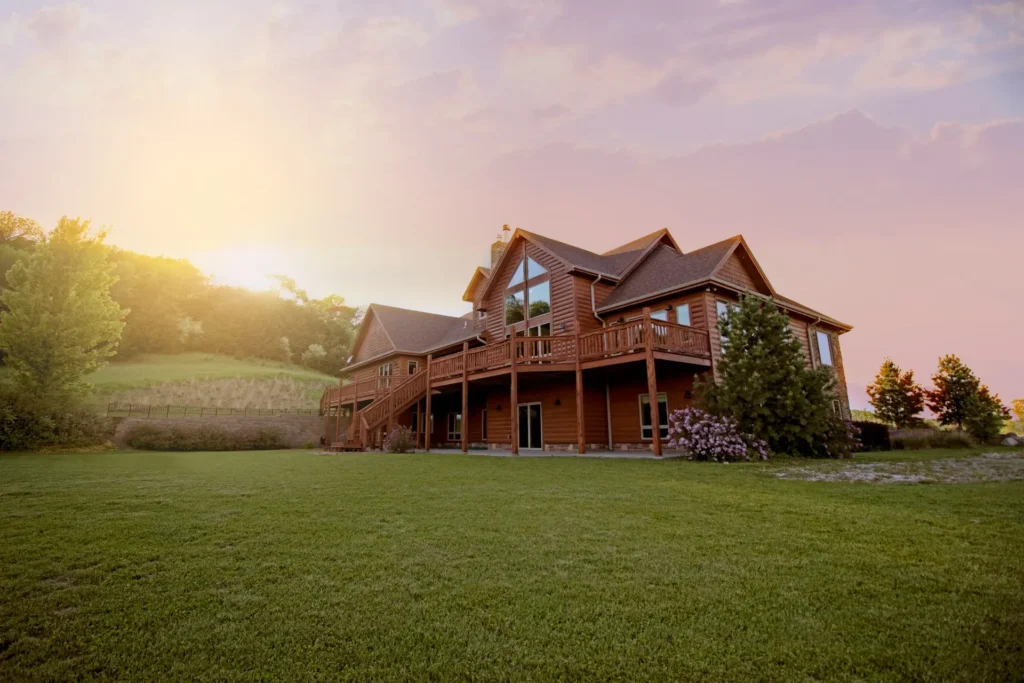 Wooden House On Green Field